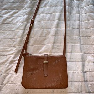 A brown pleather side purse.